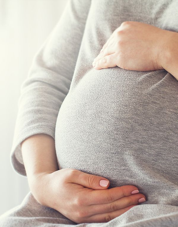 Woman holding pregnant belly